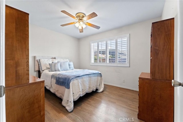 bedroom with light hardwood / wood-style floors and ceiling fan