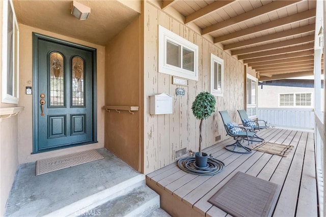 doorway to property featuring covered porch