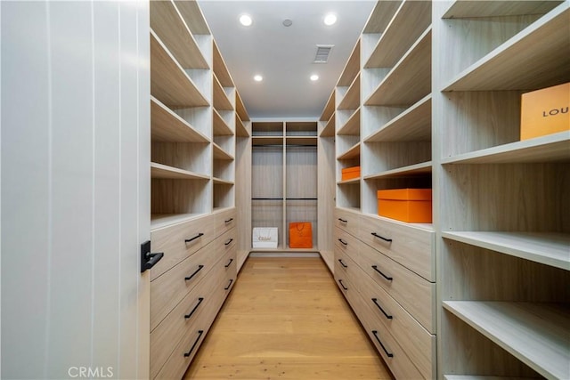 spacious closet featuring light hardwood / wood-style floors