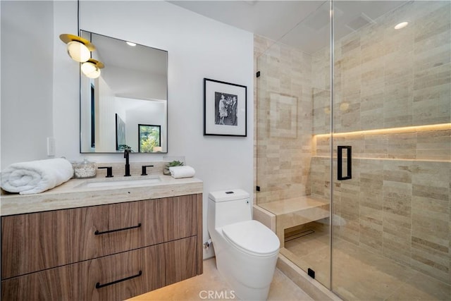 bathroom featuring vanity, toilet, and an enclosed shower