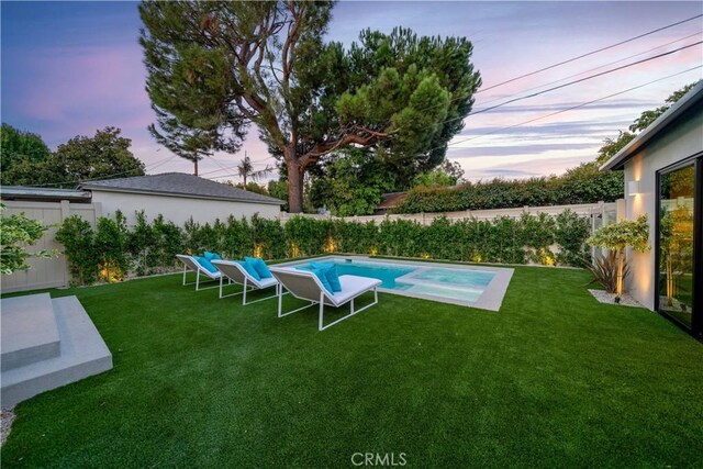 pool at dusk with a lawn