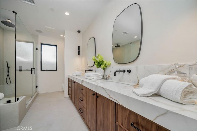 bathroom with vanity, toilet, and a shower with door