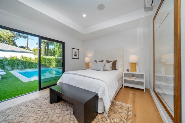 bedroom with light wood-type flooring and access to outside