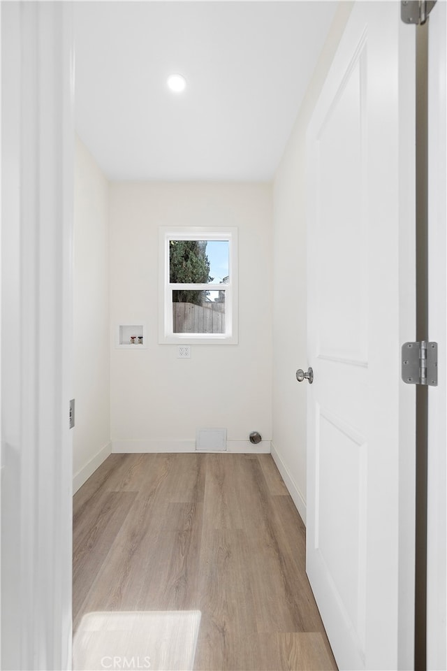 laundry room featuring hookup for a washing machine and light hardwood / wood-style flooring