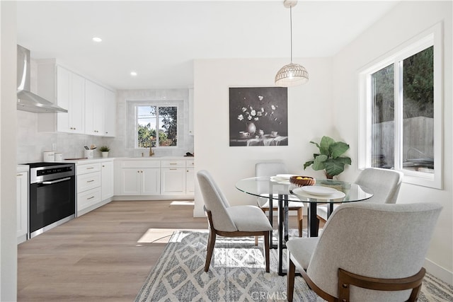 dining area featuring light hardwood / wood-style floors and sink