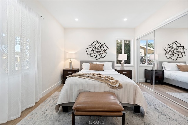 bedroom with a closet and light hardwood / wood-style flooring