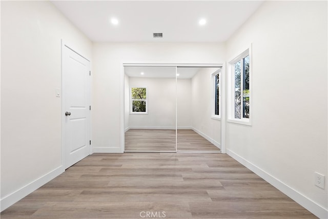 corridor featuring light hardwood / wood-style floors