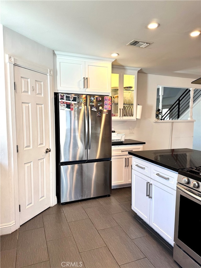 kitchen featuring white cabinets and appliances with stainless steel finishes