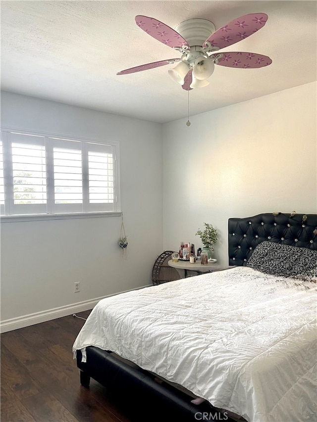 bedroom featuring ceiling fan and dark hardwood / wood-style floors