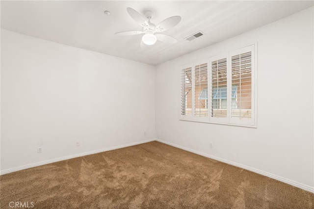 empty room with ceiling fan and carpet