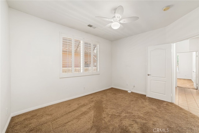 carpeted empty room featuring ceiling fan