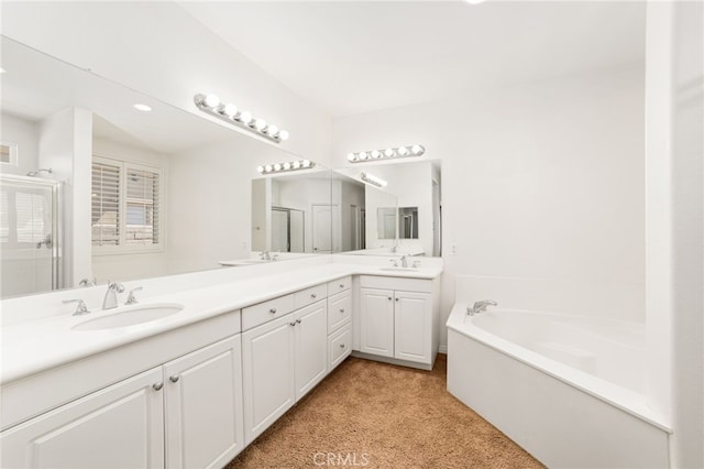 bathroom with vanity and a tub to relax in