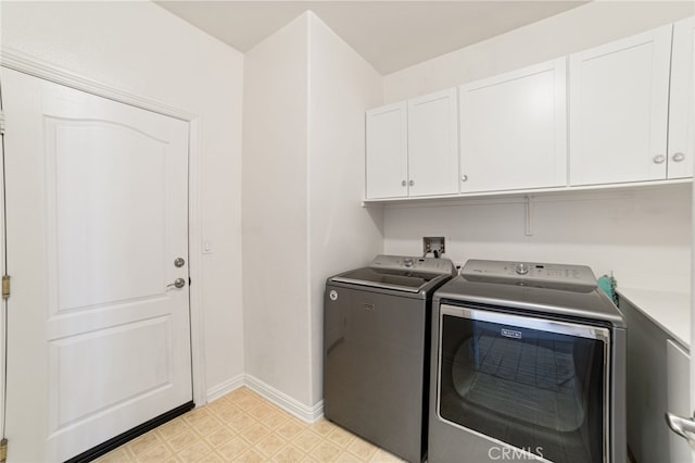 laundry area featuring cabinets and separate washer and dryer