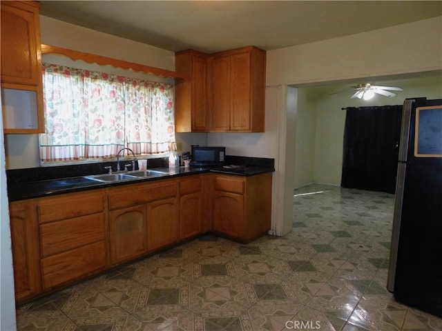 kitchen with ceiling fan, black appliances, and sink