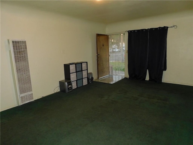 spare room with dark colored carpet