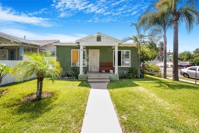 bungalow-style home with a front yard