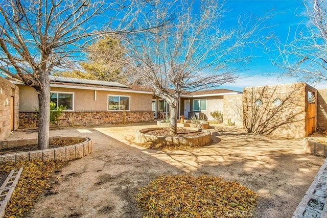 rear view of property with solar panels