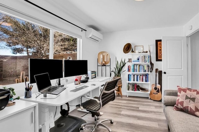 office space with a wall unit AC and light hardwood / wood-style floors