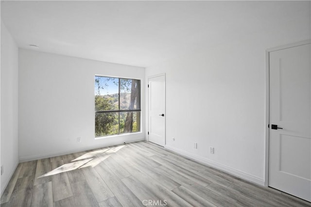 spare room featuring light hardwood / wood-style floors