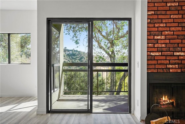 entryway featuring light wood-type flooring and a fireplace