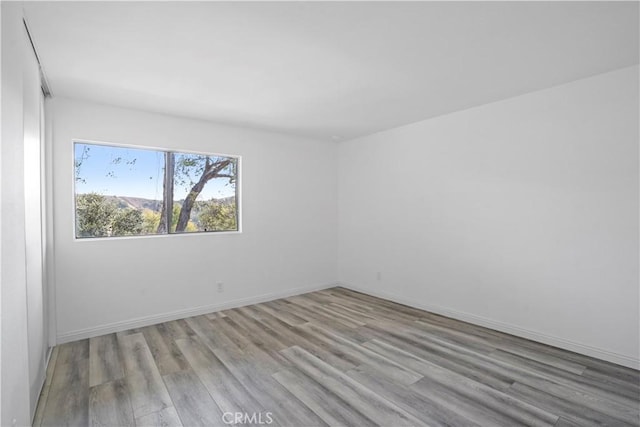 unfurnished room with light hardwood / wood-style floors