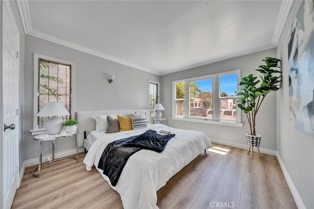 bedroom featuring crown molding and light wood-type flooring