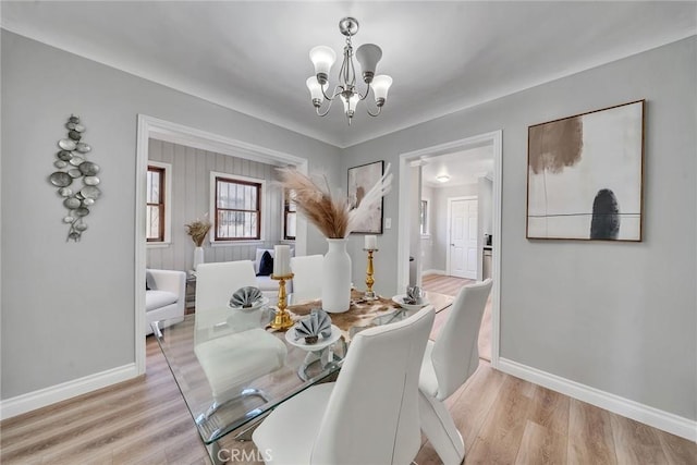 dining space featuring a chandelier and light hardwood / wood-style floors