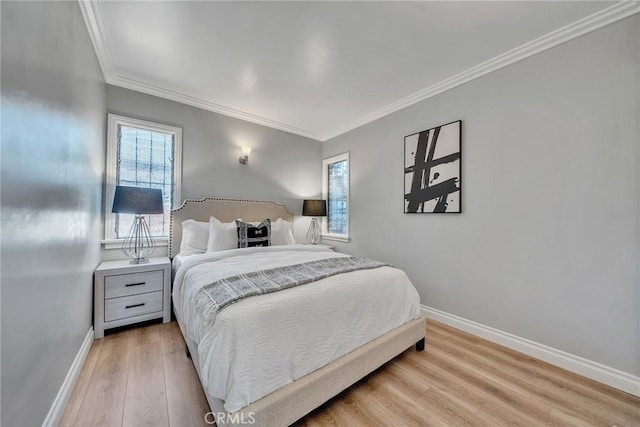 bedroom featuring light hardwood / wood-style floors and crown molding