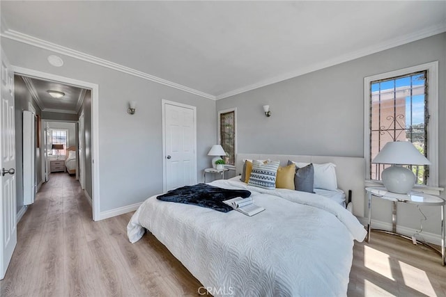 bedroom featuring light hardwood / wood-style floors and crown molding