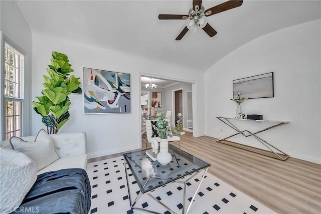 living room featuring hardwood / wood-style flooring, ceiling fan with notable chandelier, and lofted ceiling