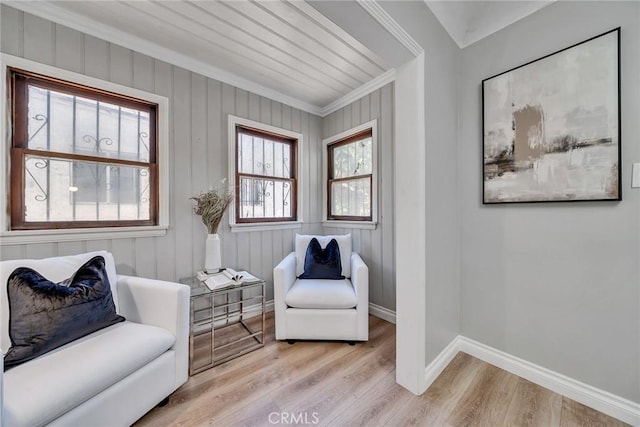 living area featuring ornamental molding and light hardwood / wood-style flooring