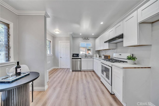 kitchen with white cabinets, white gas stove, dishwasher, and sink