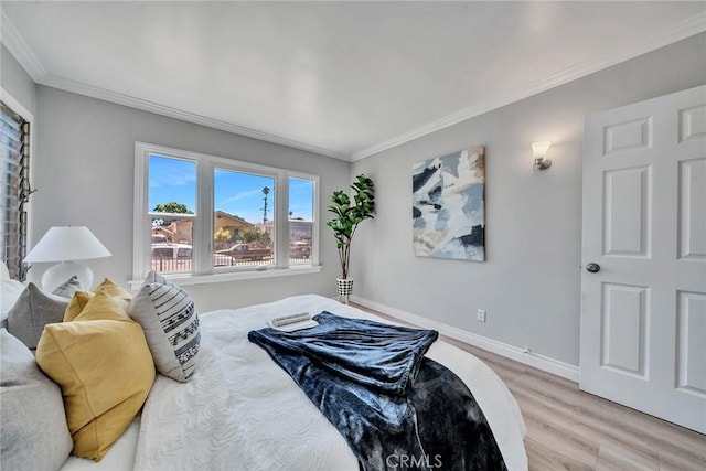 bedroom featuring wood-type flooring and ornamental molding