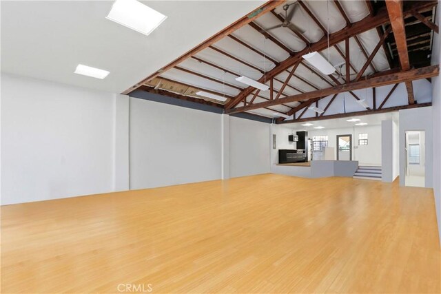 unfurnished living room featuring lofted ceiling and hardwood / wood-style flooring