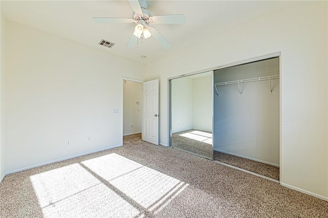 unfurnished bedroom featuring ceiling fan, a closet, and carpet flooring