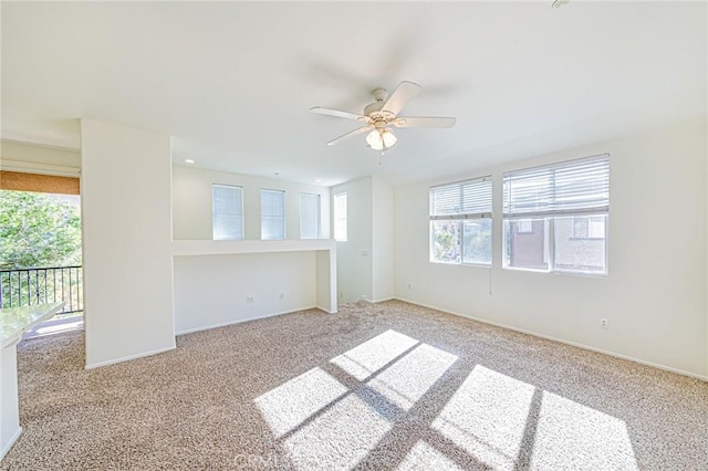 carpeted empty room with ceiling fan