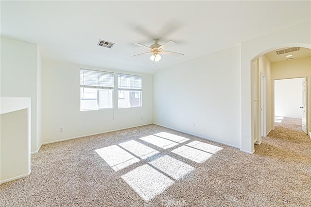 unfurnished room featuring ceiling fan and light carpet