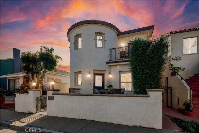 mediterranean / spanish-style home featuring a balcony