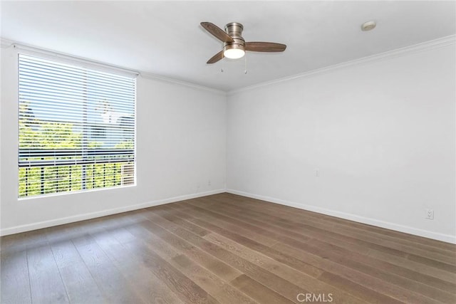 empty room with dark wood-type flooring, ceiling fan, and crown molding