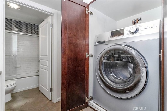 laundry room featuring light tile patterned floors and washer / clothes dryer