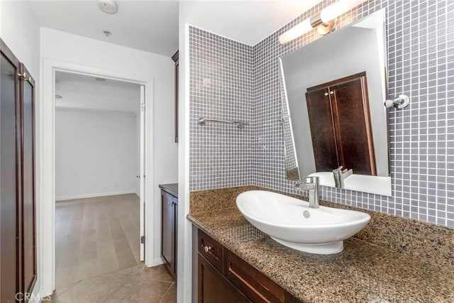 bathroom with tile patterned floors, backsplash, and sink