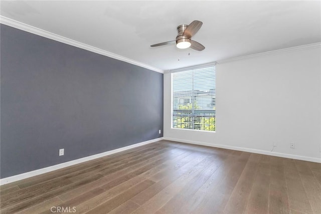 unfurnished room featuring dark hardwood / wood-style flooring, ceiling fan, and crown molding