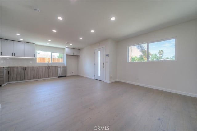 15570 Ethel St, Chino Hills, CA 91709 - unfurnished living room featuring baseboards, light wood-type flooring, a sink, and recessed lighting