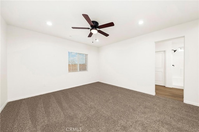 spare room featuring baseboards, dark carpet, a ceiling fan, and recessed lighting