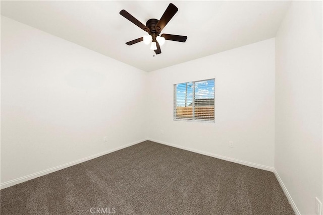 unfurnished room with dark colored carpet, ceiling fan, and baseboards