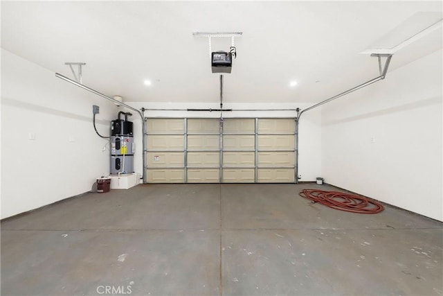 garage featuring hybrid water heater and a garage door opener