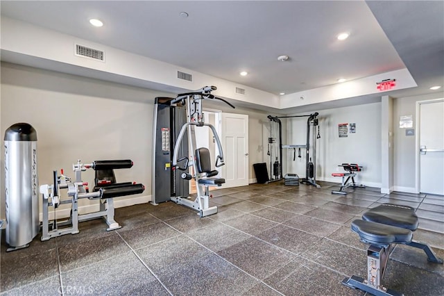 exercise room with a raised ceiling