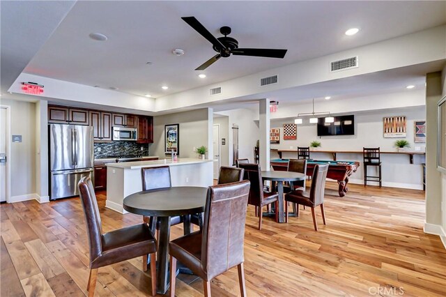 dining area featuring ceiling fan, light wood-type flooring, and billiards