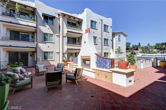 view of patio featuring an outdoor living space with a fireplace