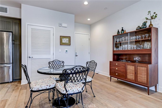 dining area with light hardwood / wood-style floors